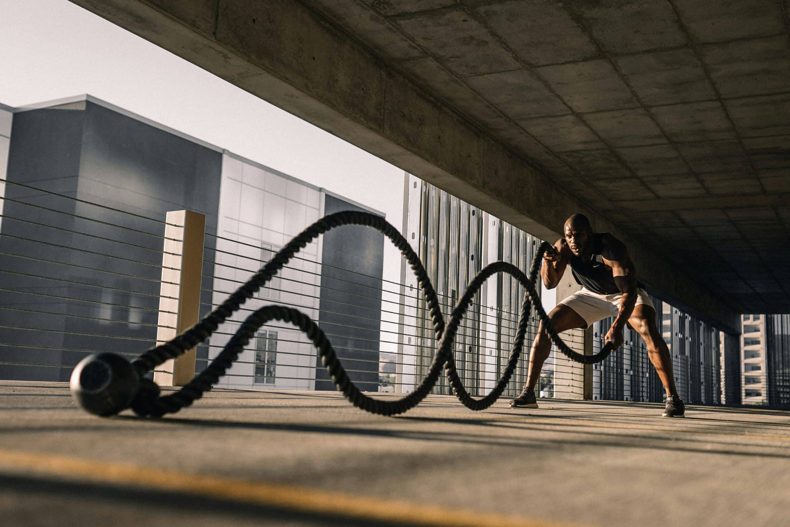An athlete training with battle ropes